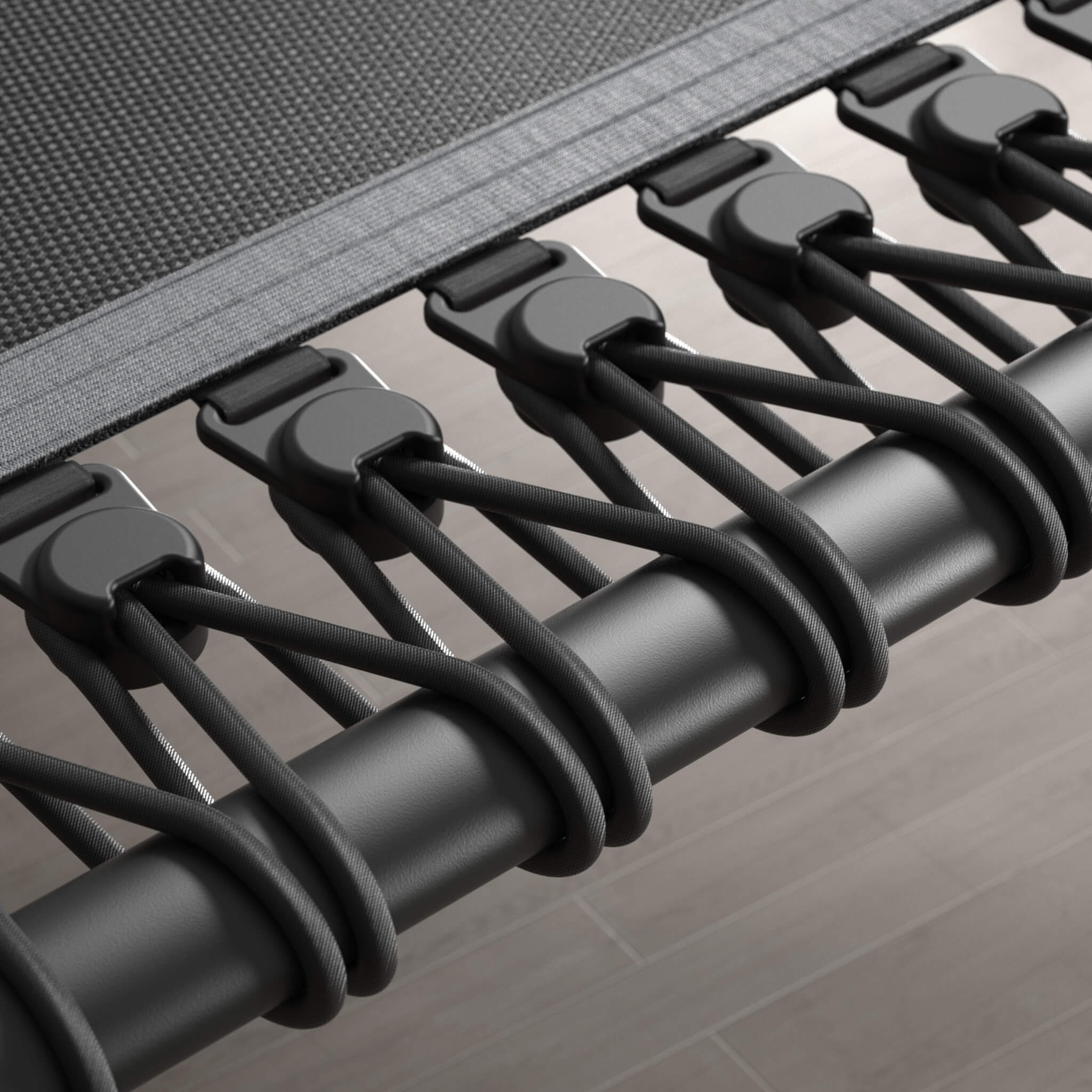 Gros plan sur les cordes élastiques d’un rebounder Acon FIT noir et hexagonal.