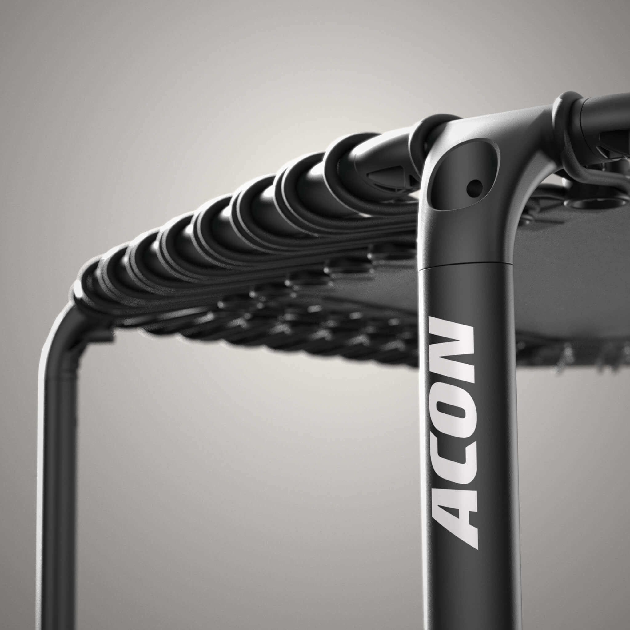 Gros plan sur un trampoline Acon FIT noir et hexagonal.