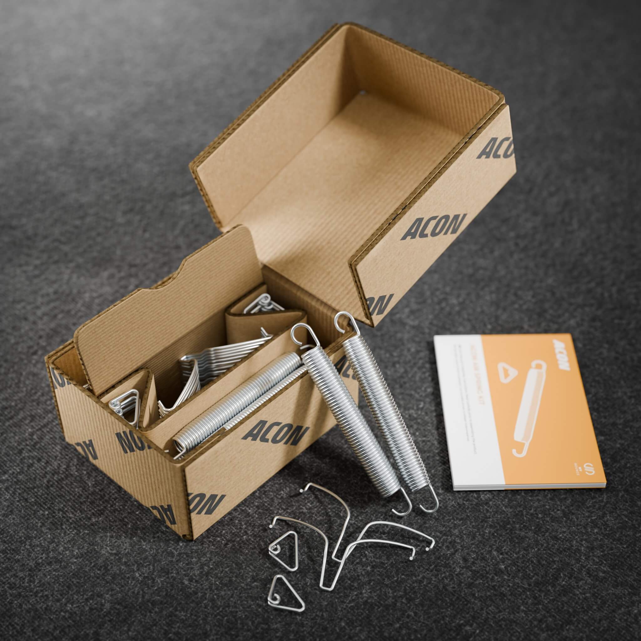 Emballage du kit de ressorts Acon Air et son jeu complet de ressorts. Comprend toutes les pièces nécessaires pour ajouter des ressorts supplémentaires, garantissant ainsi des rebonds stables et contrôlés.