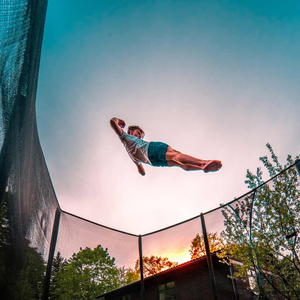Un garçon fait des figures sur le trampoline ACON.