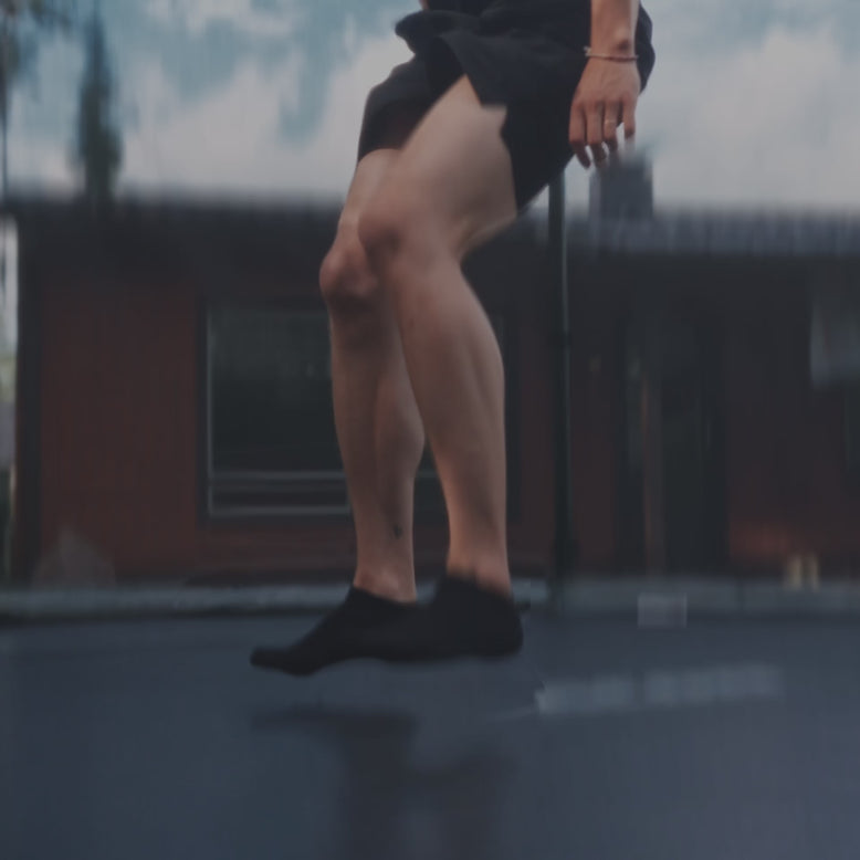 A man jumping on a round Acon Trampoline.